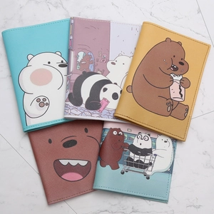 Multiple We Bare Bears PU leather passport covers with cartoon prints on marble surface