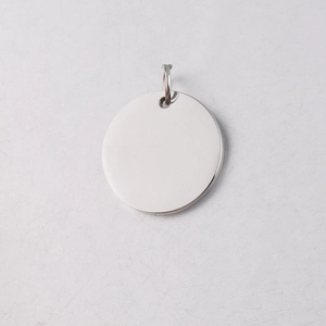 Close-up of polished silver stainless steel round pendant with connecting jump ring