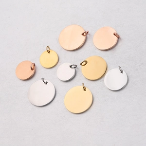 Various sizes of polished stainless steel round pendants in silver, gold, and rose gold