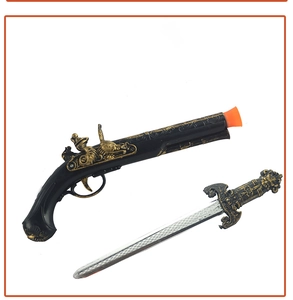 Detail of toy pirate pistol and dagger set with antique gold relief and orange safety tip