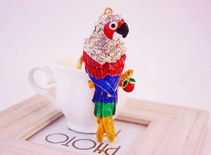 Close-up of colorful parrot keychain with enamel finish and sparkling crystal accents