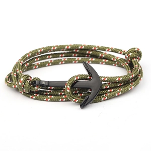 Detail of green nautical braided bracelet featuring a black anchor clasp closure