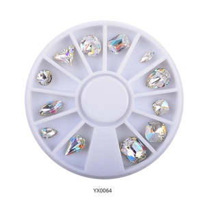 Detailed top view of 12-grid nail art rhinestone wheel with assorted crystal gems