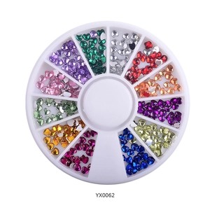Detailed top view of 12 colors heart-shaped nail rhinestones in a white round wheel box