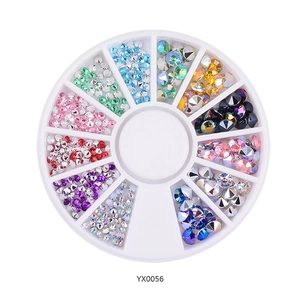 Macro shot of 12-slot wheel box with multi-color nail art rhinestones and crystal gems
