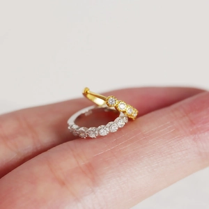 Macro shot showing small minimalist S925 silver hoop earrings with clear zircon stones