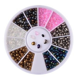 Detail of 12-grid nail art wheel with assorted rhinestones and metallic mixed beads