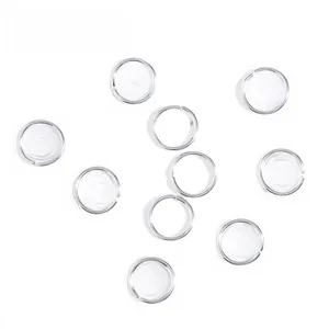 Close-up of 10 pieces silver hollow-out embossed metal rings for dreadlock hair extensions