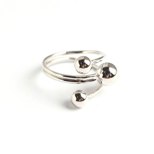 Minimalist silver multi-layer open ring with ball details on a white background