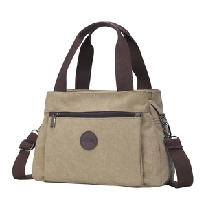 Vintage khaki canvas tote bag with brown straps and adjustable shoulder strap for women