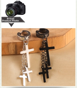 Detailed shot of punk style stainless steel cross pendant earrings in black and silver