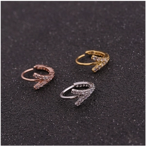 Three zirconia-encrusted huggie rings in gold, silver, and rose gold finishes