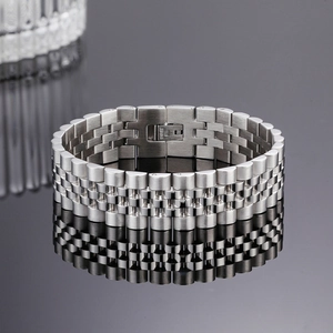 Detailed close-up of a silver stainless steel bracelet clasp with engraved material label