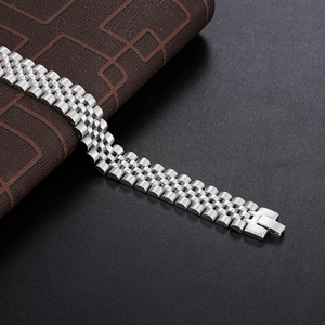 Polished silver stainless steel link bracelet with folding clasp on textured background