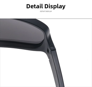 Close-up of black sports sunglasses with metal screw hinges and gray lenses