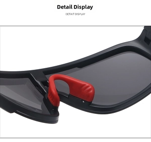 Close-up of adjustable red non-slip rubber nose pads on matte black sports cycling sunglasses