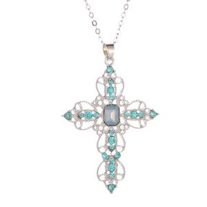 Elegant silver cross necklace with blue rhinestones and hollow filigree design