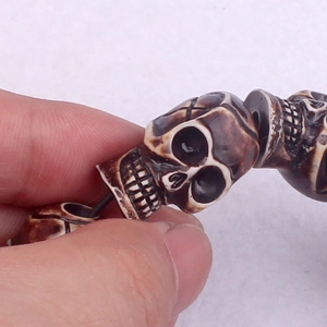 Punk style skull bead bracelet with elastic cord and antique faux bone carved details