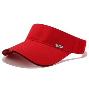 Detail of red sport sun visor with metal emblem and stylish black brim piping