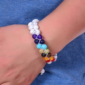Double-layer white turquoise chakra beaded bracelet worn on wrist against denim