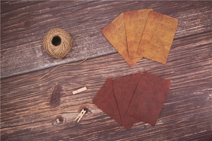 Flat lay of vintage kraft envelopes on wood with hemp rope and wooden clips