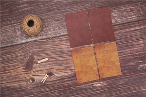 Vintage style thick kraft paper envelopes in burgundy and brown on dark wood texture