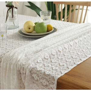 Nordic vintage white cotton lace tablecloth with hollow patterns on a wooden table