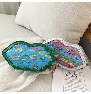 Detail of colorful sequined lip-shaped handbags with golden chain straps for kids