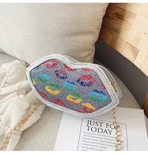 Detailed macro shot of silver sequined lip-shaped kids bag with colorful patterns