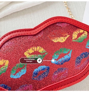 Close-up of red glitter lip-shaped crossbody bag with colorful rainbow print details