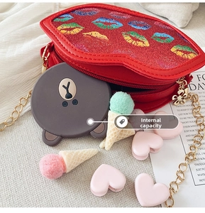 Macro view of red glitter lip-shaped crossbody bag interior storage and metal chain strap
