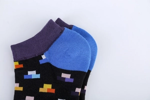 Detail view of cotton ankle socks with vibrant geometric patterns and colored heel