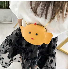 Close-up of yellow cartoon chick crossbody bag with gold chain strap for kids