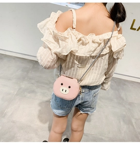 Pink pig cartoon crossbody bag for kids with black and white striped strap back view