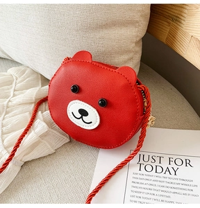 Detail shot of red bear crossbody bag showing PU leather texture and snowflake zipper charm