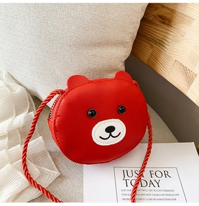 Detail of red bear-shaped mini shoulder bag for kids with rope strap and golden zipper