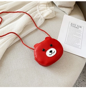 Detail of red cartoon bear crossbody bag for children with woven rope strap