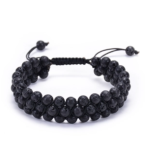 Detail of double-layer lava stone beaded bracelet with adjustable woven cord and matte texture