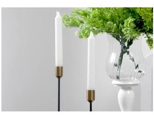 Detail view of modern Nordic candlesticks with black slim stems and golden holders