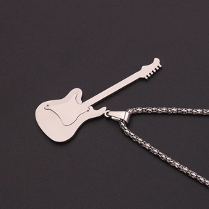 Macro detail of a polished silver electric guitar pendant on a metallic chain necklace