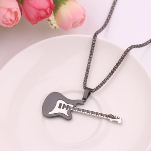 Detailed view of a black and white electric guitar pendant on white ceramic plate