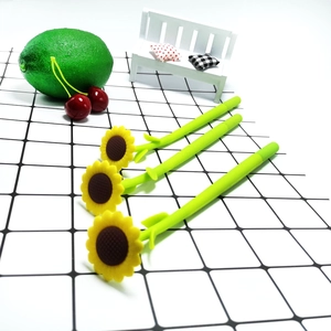 Three creative sunflower gel pens with green leaf stems on a black and white grid