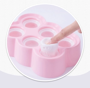 Detailed view of pink silicone popsicle mold with cute cat shape being popped out