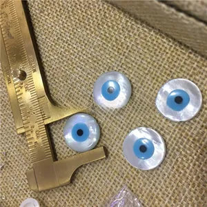Detail shot of natural white mother of pearl evil eye shell beads measured by calipers