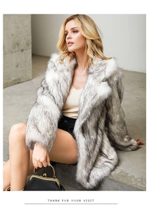 Close-up of the long-haired faux fur texture on a grey and white ombre winter coat