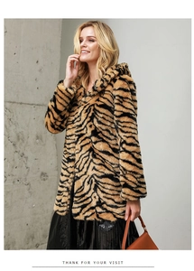 Detailed texture of mid-length faux fur coat featuring bold tiger print and large hood