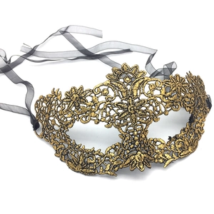 Detailed close-up of vintage golden lace embroidery mask with black ribbon ties