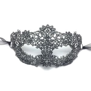 Close-up of silver-gray lace masquerade mask with intricate floral embroidery and ribbons