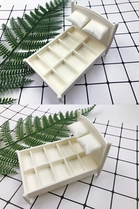 Detail shot of mini bed-shaped sponge holder with grid frame and dual pillows