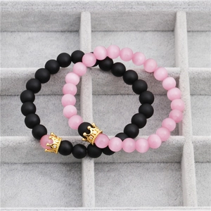 Close-up of crown beaded bracelets with blue cat eye stone and black matte beads